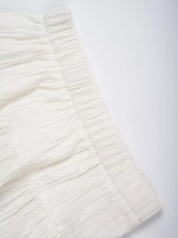 Close-up of a textured white fabric on a light gray background