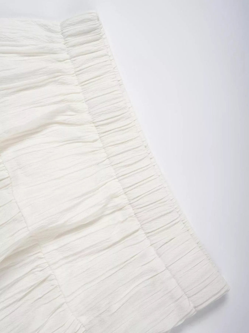 Close-up of a textured white fabric on a light gray background