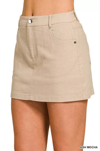 Beige skirt worn by a person on a white background