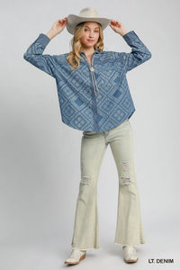 Woman wearing a light denim patterned shirt and light green pants on a white background