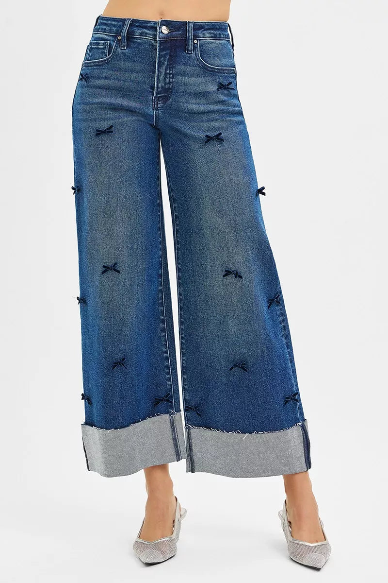 Blue wide-leg jeans with decorative elements on a white background