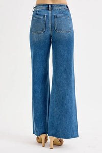 Blue jeans worn by a person on a white background