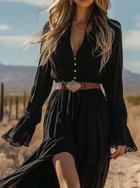 Woman wearing a black dress with long sleeves and a belt in a desert setting