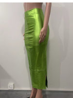 Green leather skirt worn by a person on a plain background