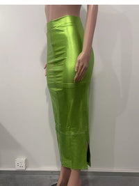 Green leather skirt worn by a person on a plain background