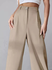 Beige pants worn by a person on a gray background