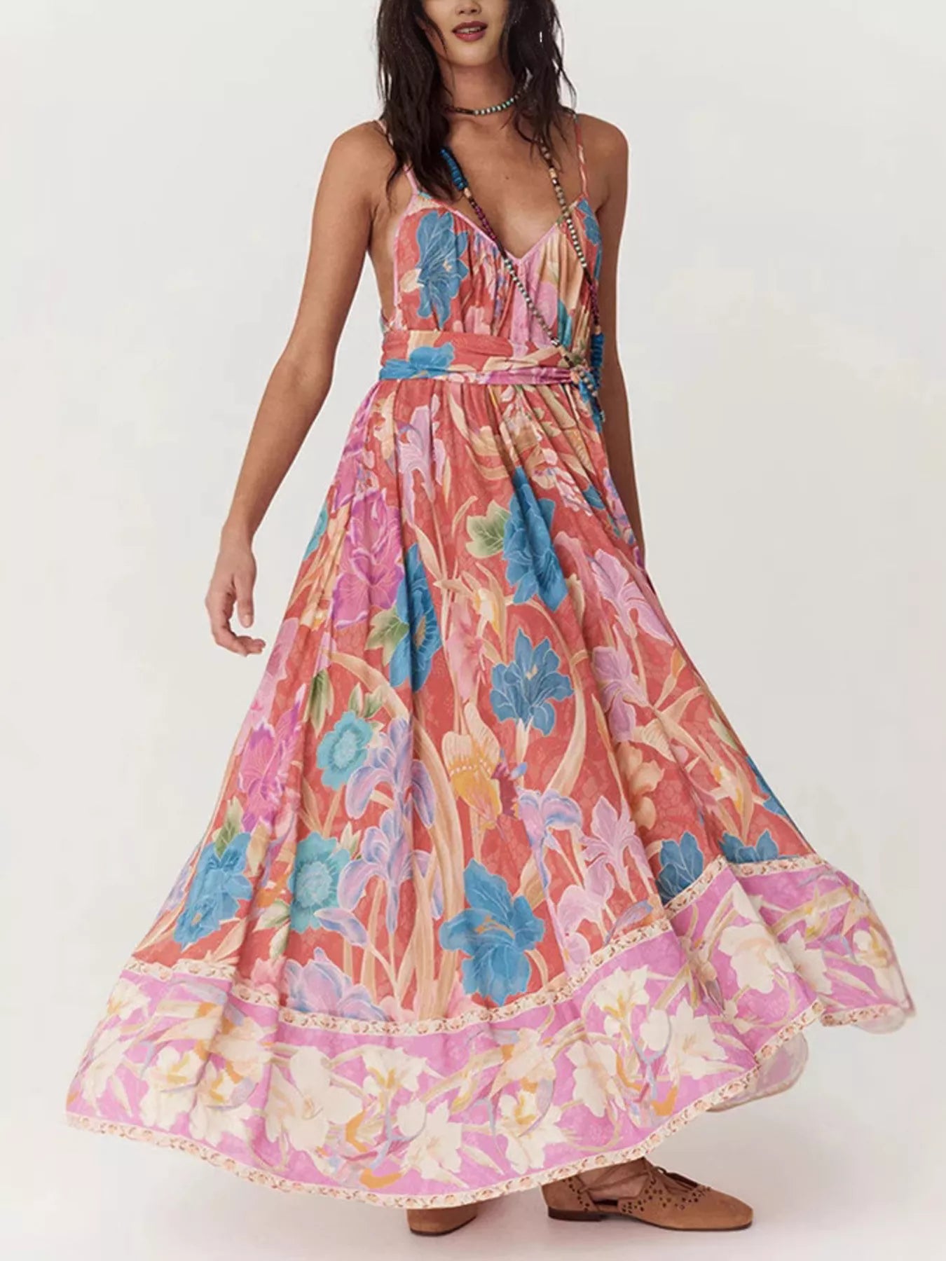 Woman wearing a colorful floral dress on a white background