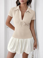 Woman wearing a beige checkered dress with a white background