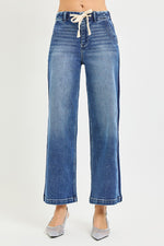 Blue jeans with a drawstring waist on a white background