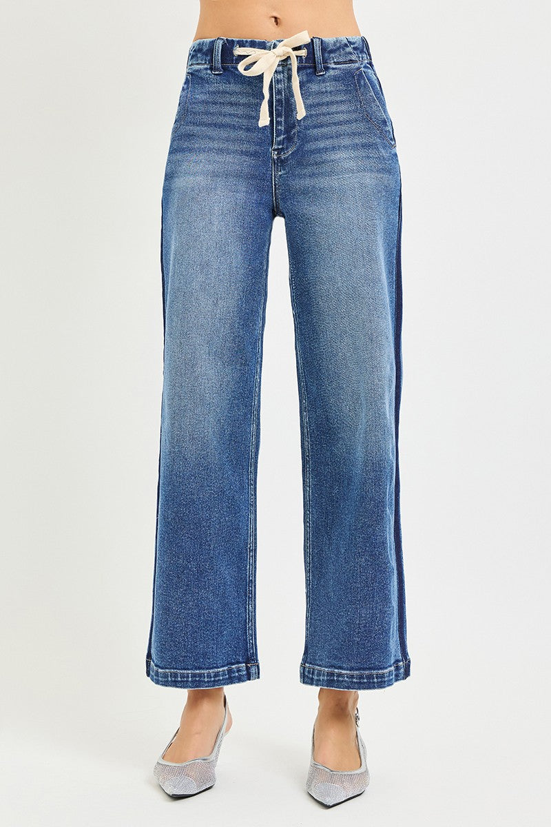 Blue jeans with a drawstring waist on a white background