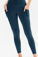 Blue leggings worn by a person on a white background