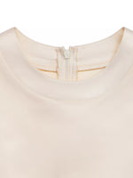 Close-up of a beige fabric with a zipper detail on a white background