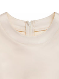 Close-up of a beige fabric with a zipper detail on a white background