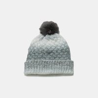 Knitted beanie with a pom-pom on a white background
