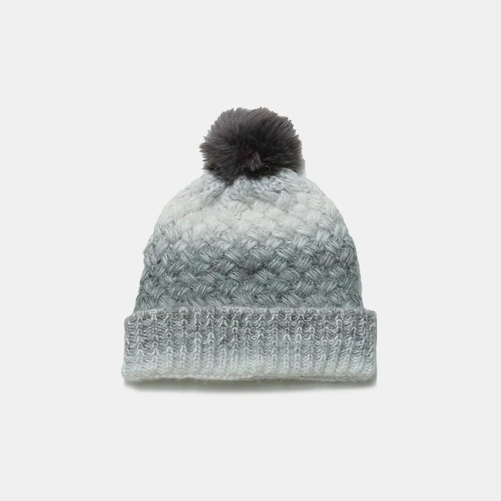 Knitted beanie with a pom-pom on a white background