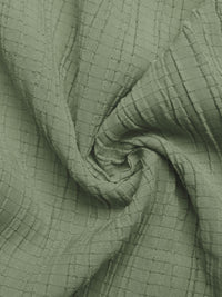 Close-up of green textured fabric with a grid pattern