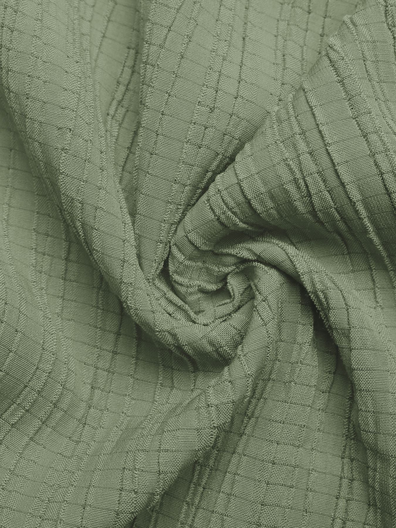 Close-up of green textured fabric with a grid pattern
