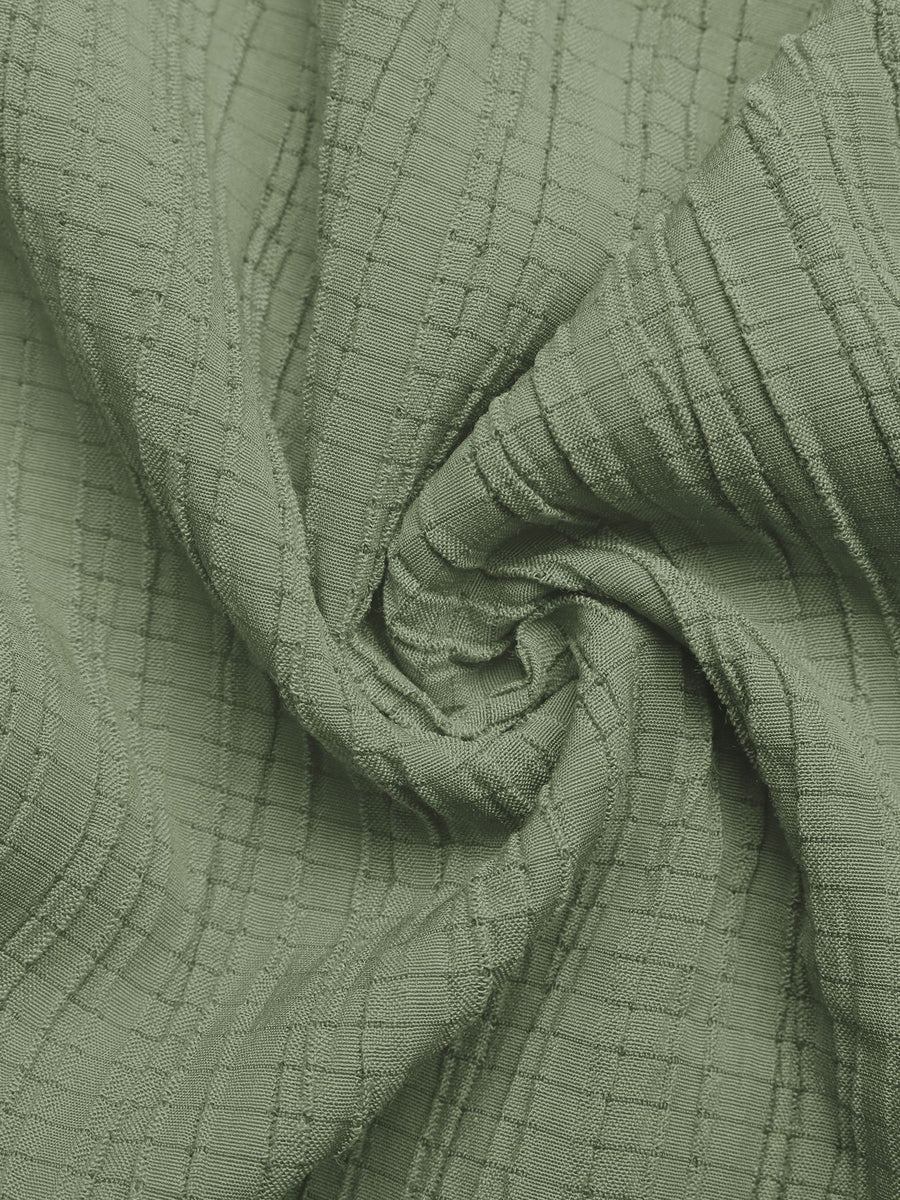 Close-up of green textured fabric with a grid pattern