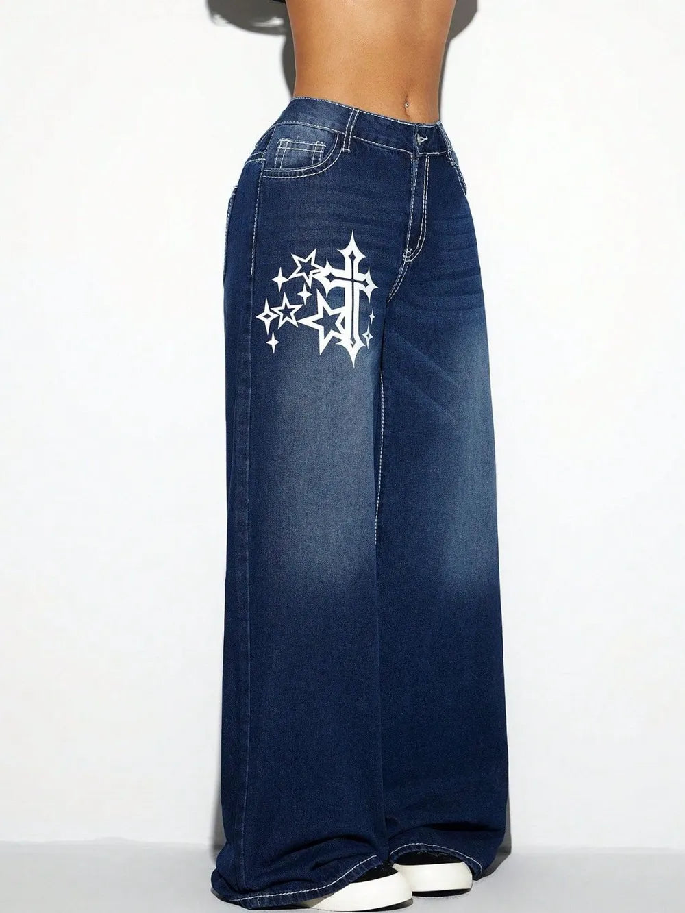 Blue jeans with a white star and cross design on a white background