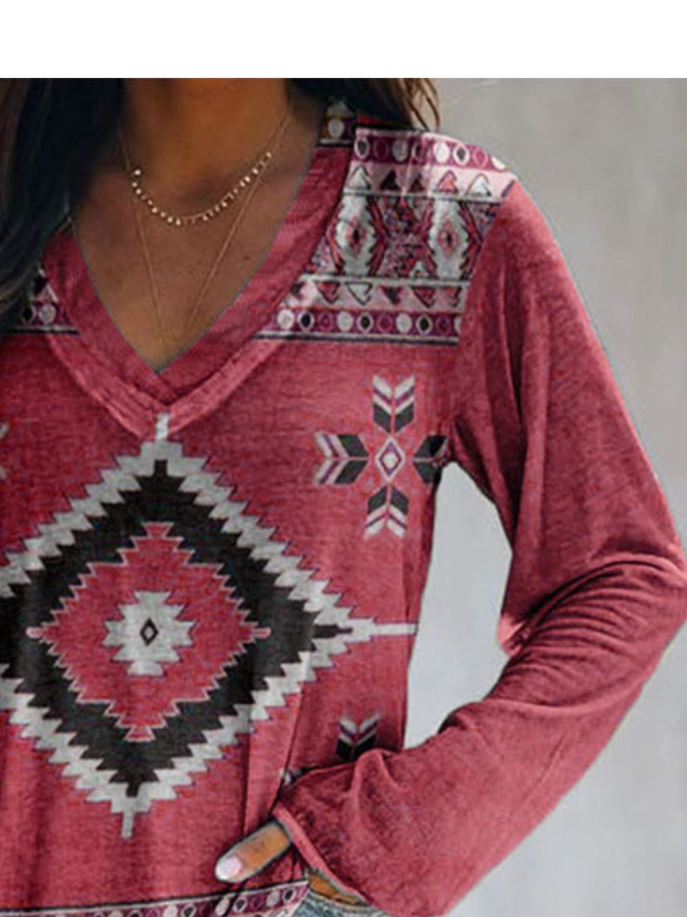Red patterned hoodie worn by a person on a neutral background