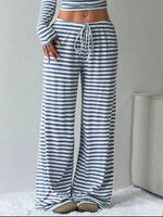 Person wearing blue and white striped pants with a gray background