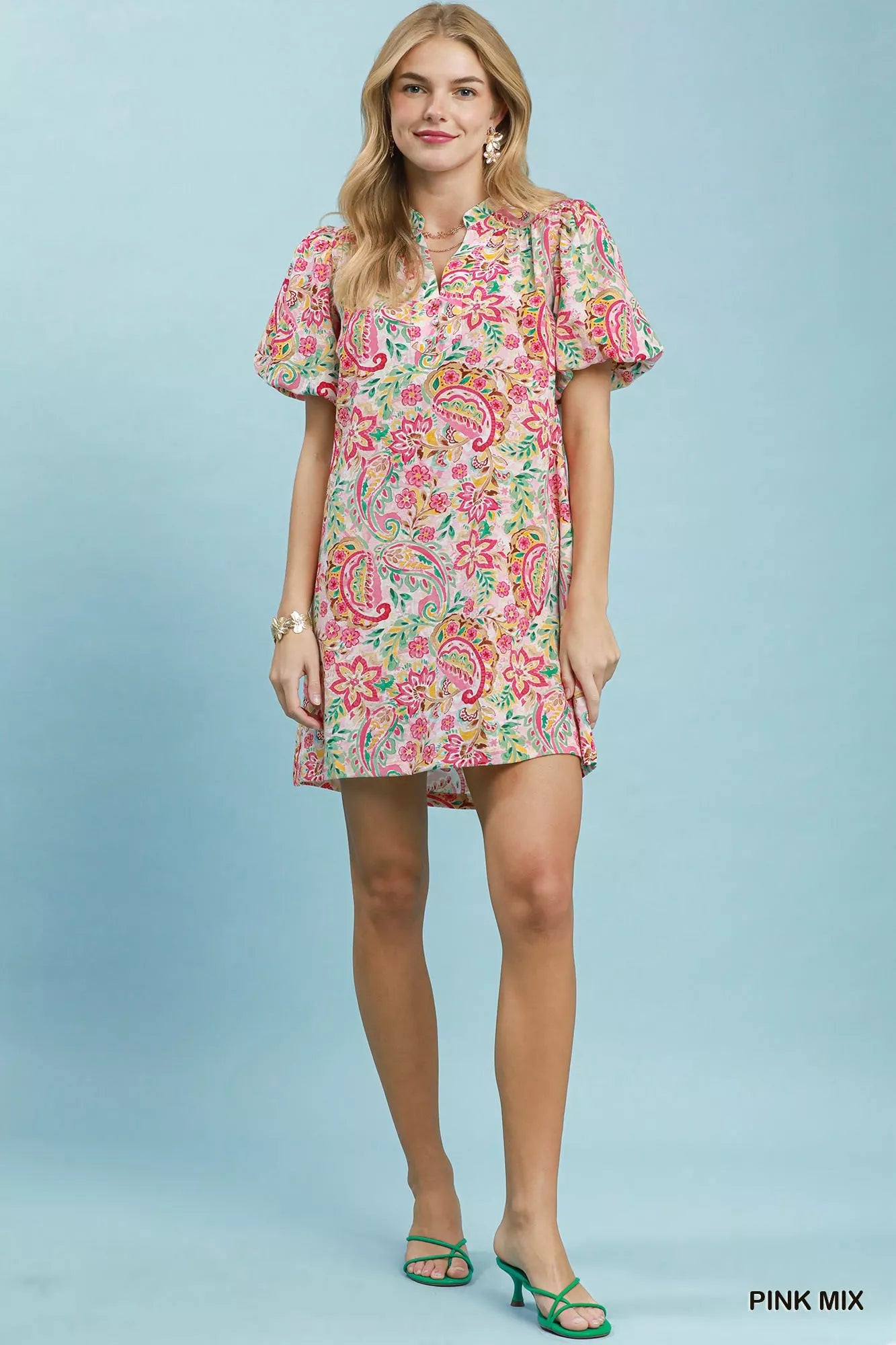 Woman wearing a floral dress against a light blue background