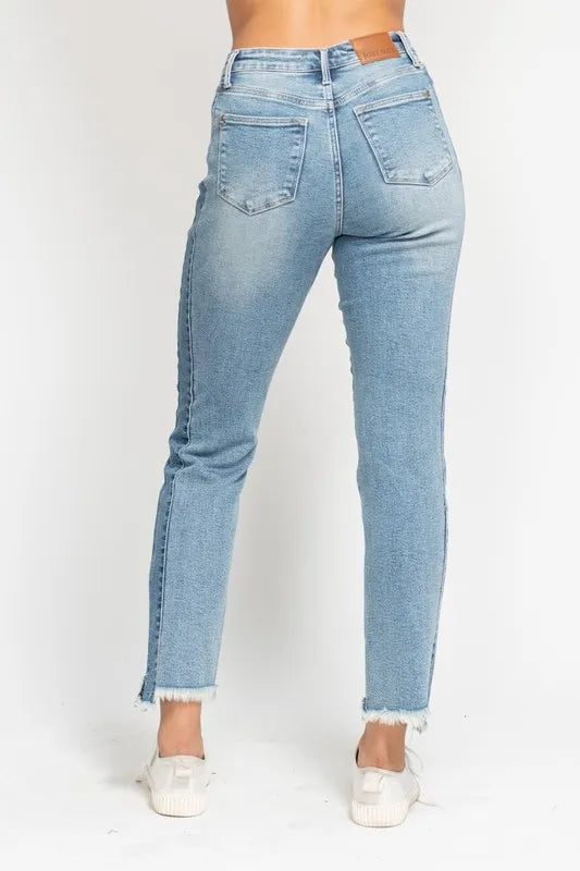 Light blue jeans worn by a person on a white background