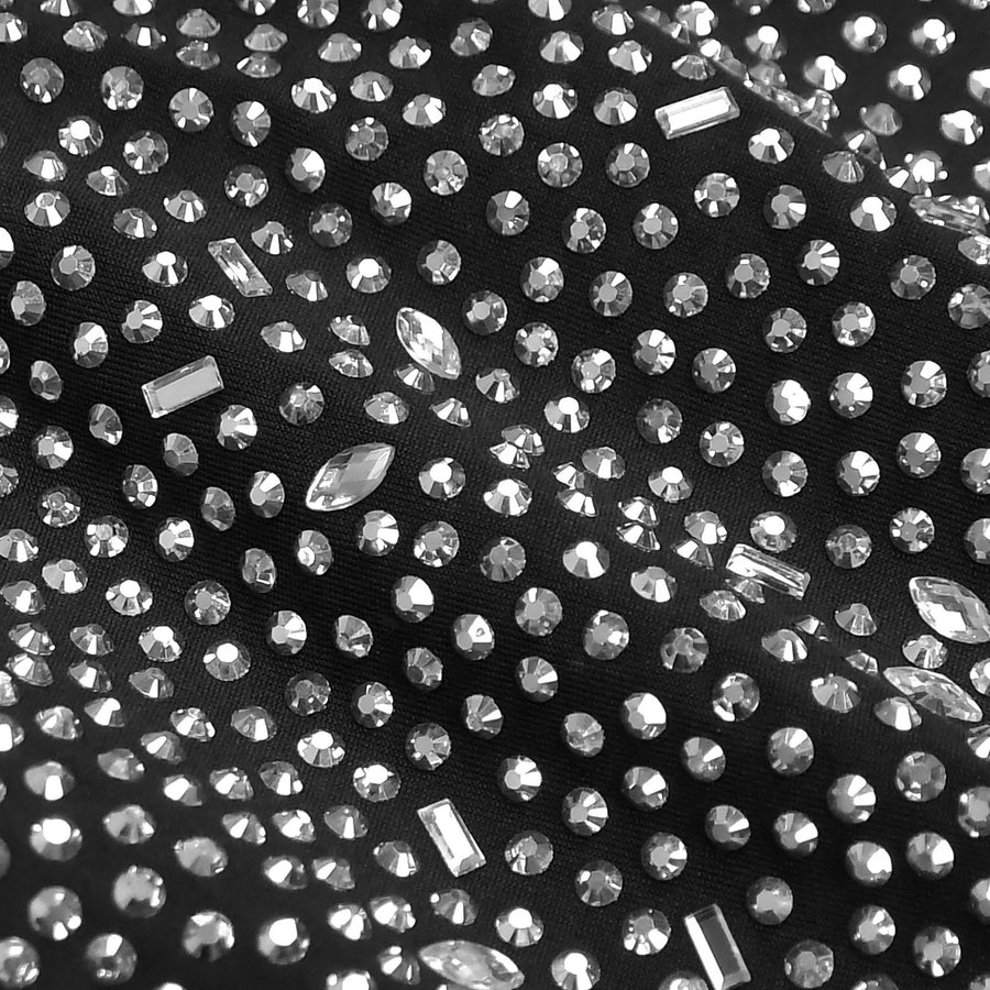 Close-up of black fabric with embedded clear rhinestones