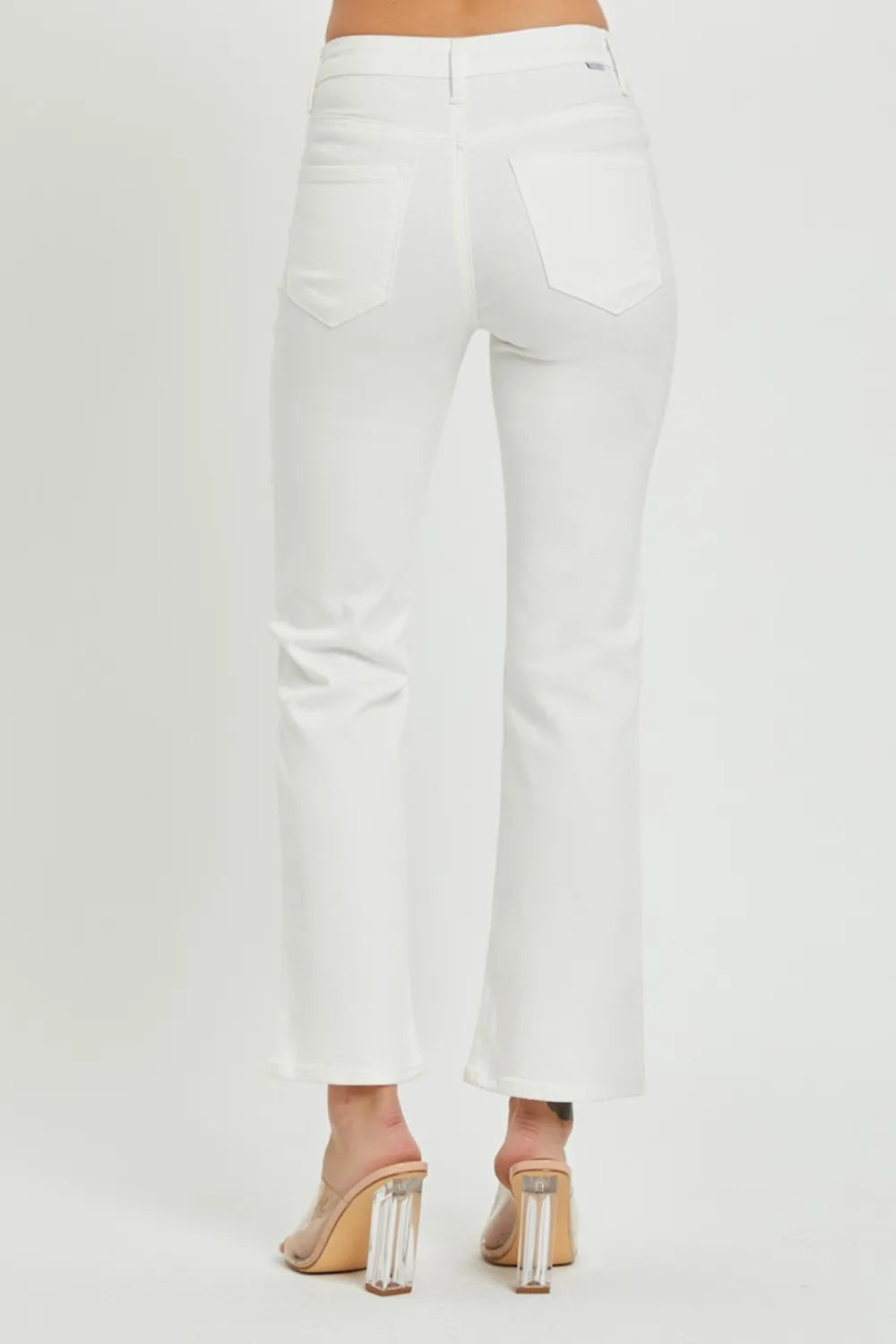 White pants worn by a person on a white background