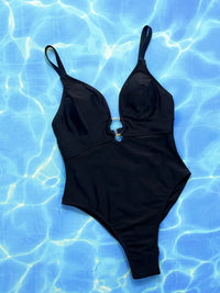 Black swimsuit on a blue water background