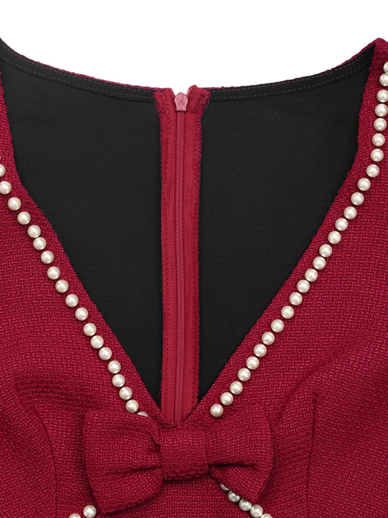 Red garment with pearl detailing and a black interior