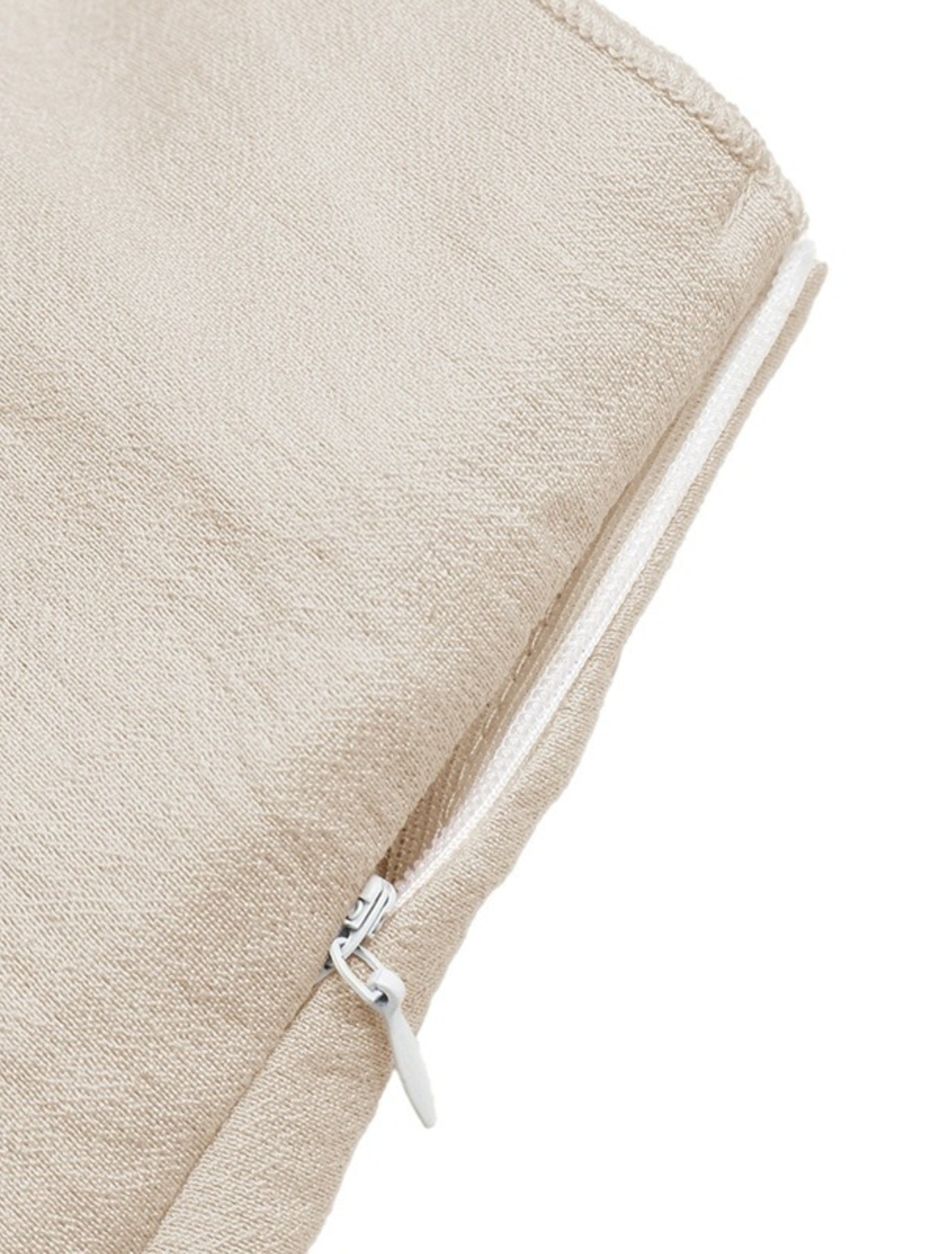 Close-up of a beige fabric pouch with a silver zipper on a white background