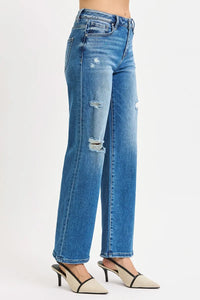 Blue jeans with slight distressing on a white background