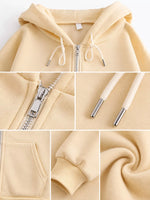 A collage showing a light cream-colored zip-up hoodie from multiple angles, including the hood, zipper detail, drawstrings, pocket, cuff, and fabric texture.