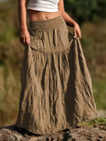 Person wearing a long, tiered skirt outdoors with a blurred natural background