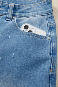 Close-up of a blue denim pocket with a phone inside