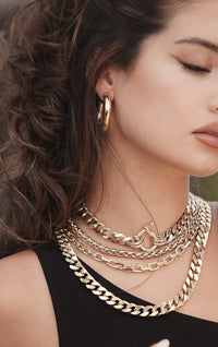 Model wearing several Esmé Necklace