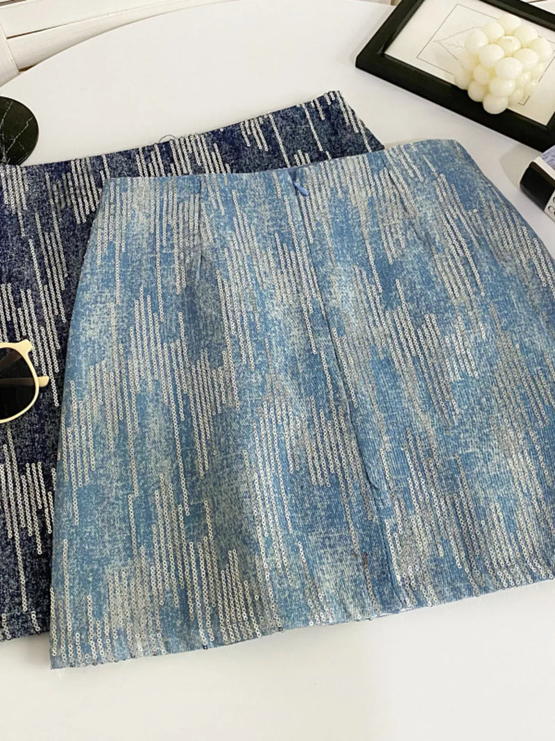 Two blue patterned placemats on a white surface with sunglasses and a framed picture in the background.