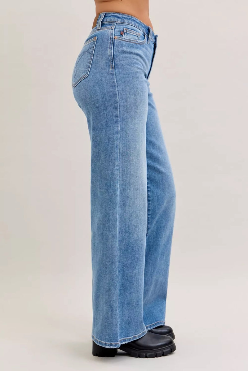 Blue jeans worn by a person on a light gray background