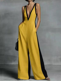 Yellow jumpsuit with black accents worn by a person against a gray background