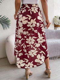 Person wearing a maroon floral skirt in a home setting