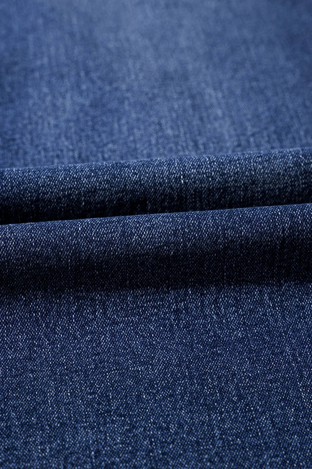 Close-up of blue denim fabric with a textured pattern