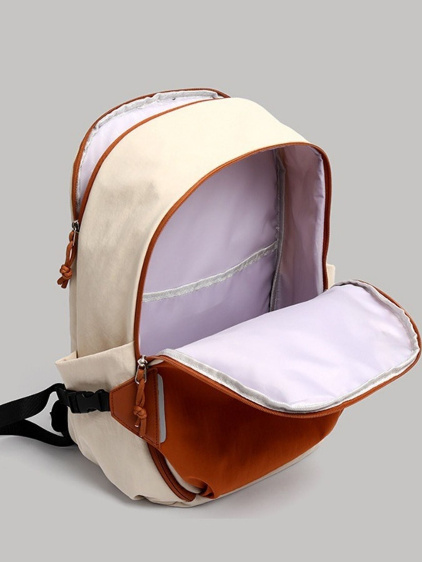 Beige and brown backpack with open front compartment on a gray background