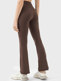Brown high-waisted pants worn by a person on a white background
