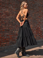 Woman wearing a black dress with a brick wall background