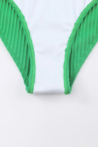 Close-up of green ribbed trim on a white garment