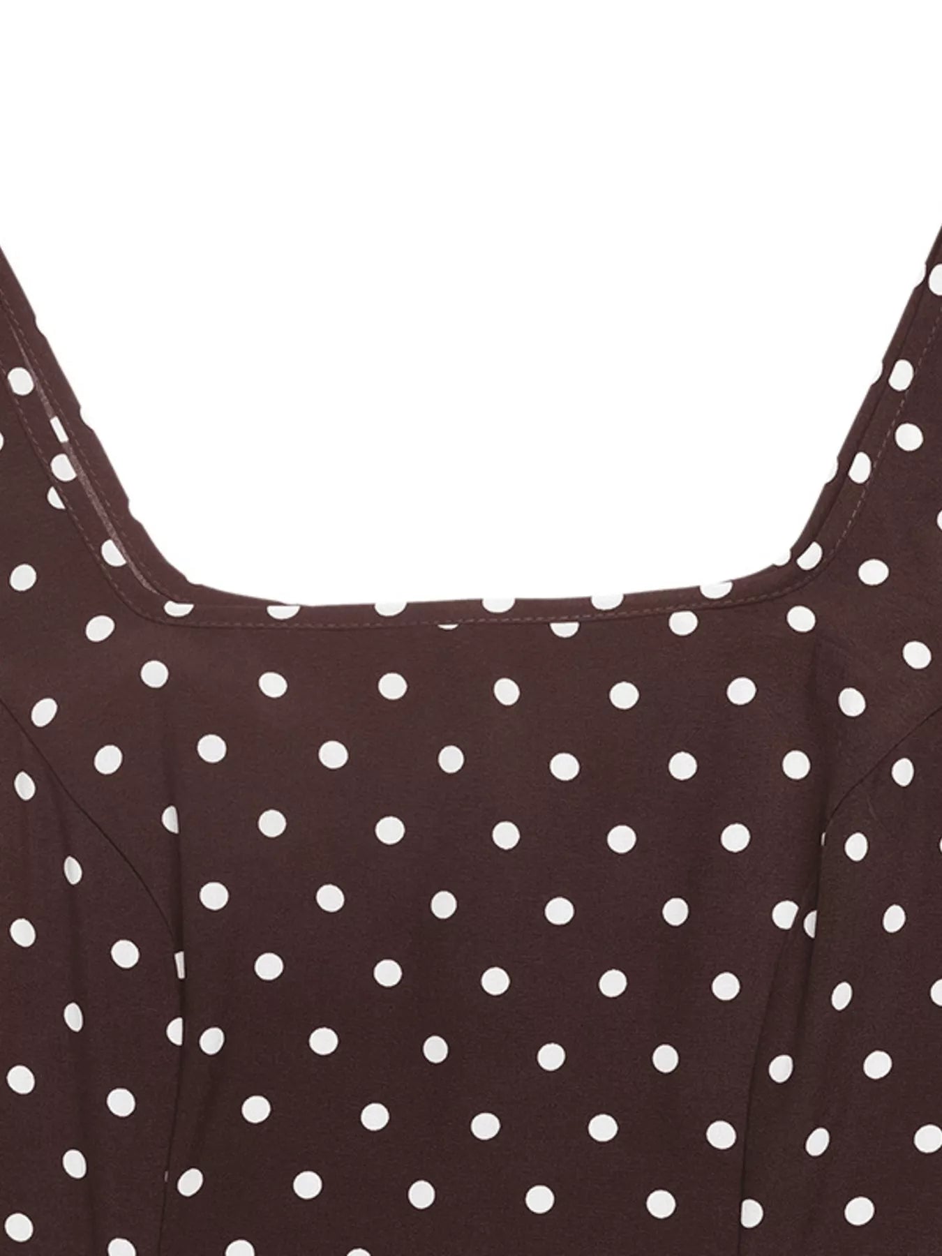Close-up of a brown dress with white polka dots on a white background