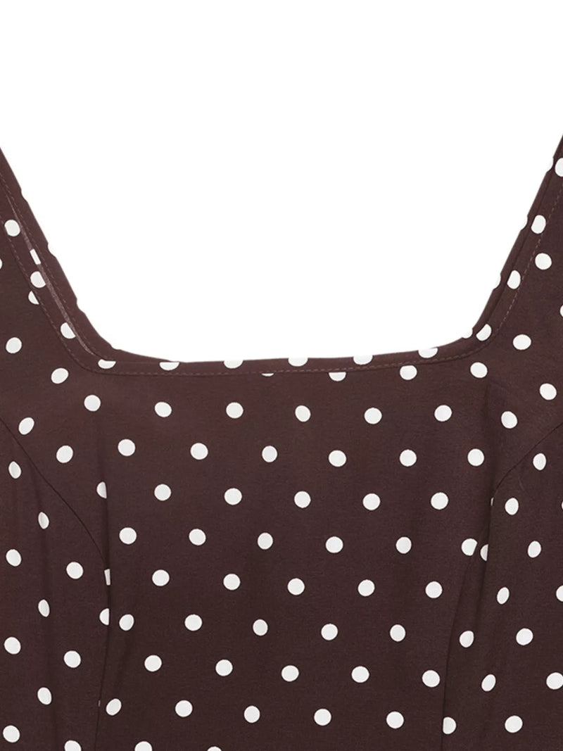 Close-up of a brown dress with white polka dots on a white background