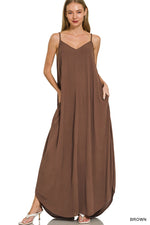 Woman wearing a brown slip dress on a white background