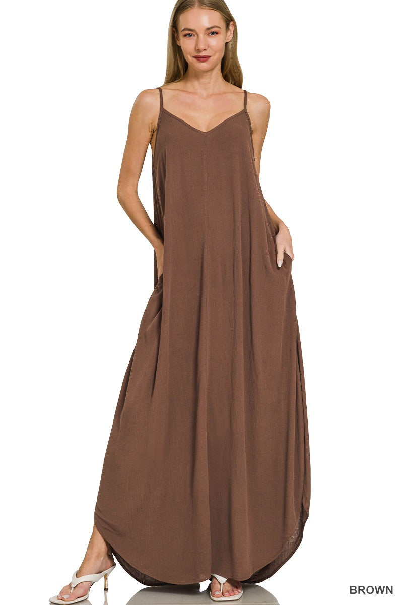 Woman wearing a brown slip dress on a white background